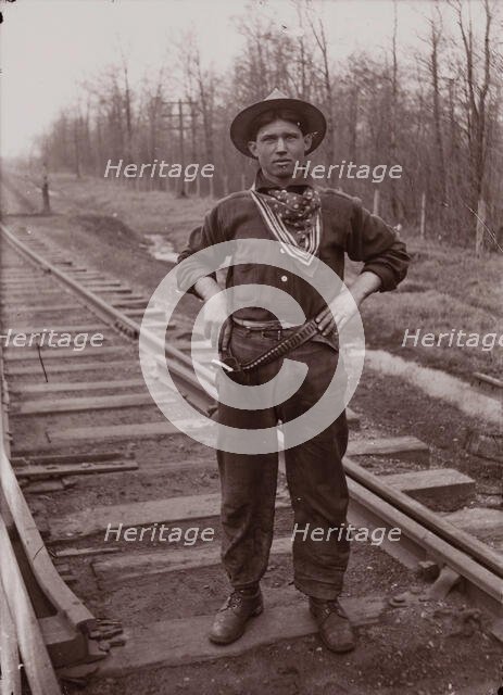 Untitled (man with pistol on railroad tracks, neg. #14), between 1910 and 1935, printed c1975. Creator: Wendell Hotter.