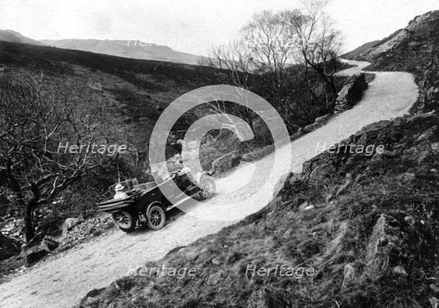 A Morris Oxford climbing a steep hill in the Lake District, Cumbria, (c1920s?). Artist: Unknown