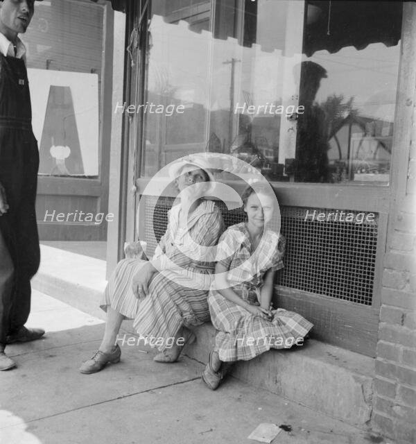 Farm folk spend a day in town, Eden, Alabama, 1936. Creator: Dorothea Lange.