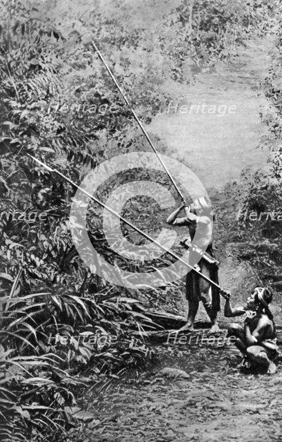 Kenyah men hunting for monkeys with blowpipes, Borneo, 1922. Artist: Dr Charles Hose
