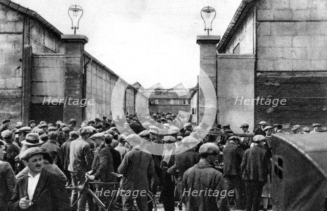 Workers at the entrance of a Billancourt factory, Paris, 1931.Artist: Ernest Flammarion