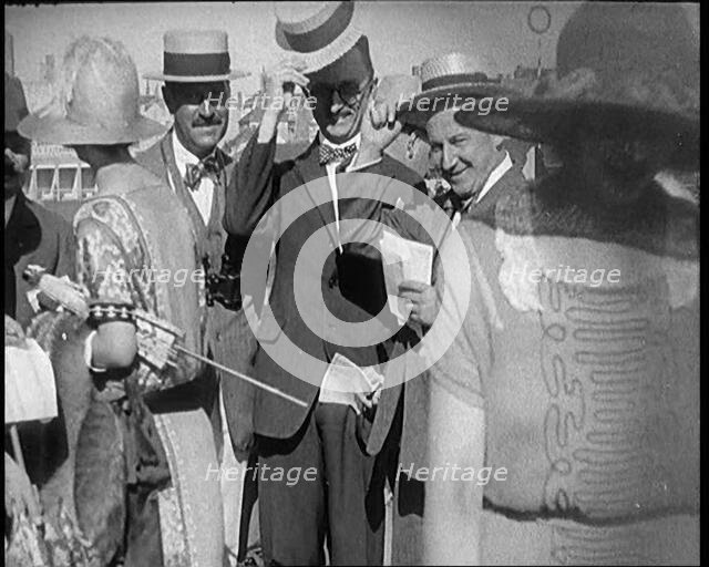 Civilians Wearing Smart Outfits and Hats Posing for the Camera During a Horse Race, 1920. Creator: British Pathe Ltd.