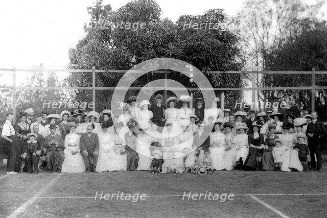 Possibly City Electric Light company employees and their families on a tennis court, 1903. Creator: Robert Augustus Henry L'Estrange.