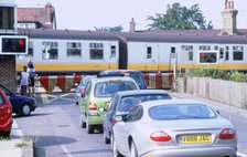 Traffic queue at level crossing in Brockenhurst, Hampshire. Artist: Unknown.