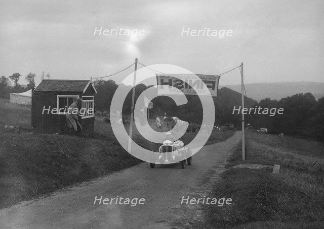 Car crossing the finishing line at the MAC Shelsley Walsh Speed Hill Climb, Worcestershire, 1935. Artist: Bill Brunell.