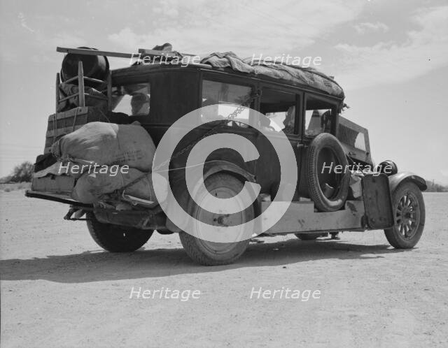 Family...from Fort Smith, Arkansas, trying to repair their car..., Arizona, 1937. Creator: Dorothea Lange.