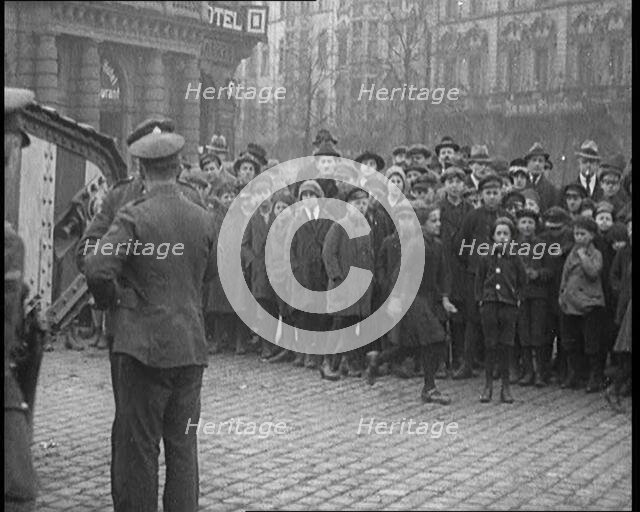 British Soldiers Standing by a Tank in a German Town as Civilians Look On, 1921. Creator: British Pathe Ltd.