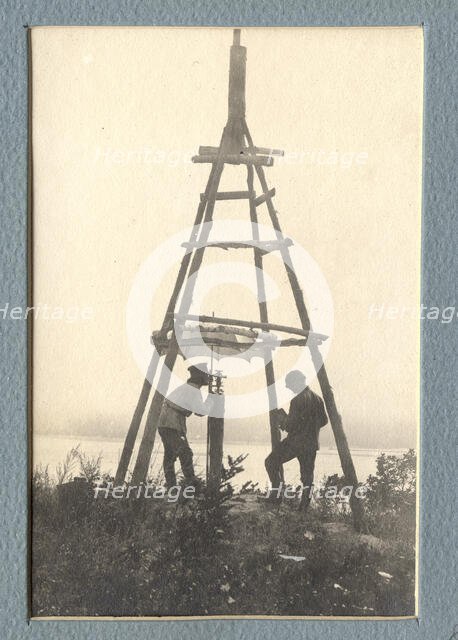 The moment of carrying out triangulation measurements under a tower on the river bank, 1909. Creator: Vladimir Ivanovich Fedorov.