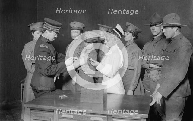 Major Connell inoculating woman motorist, 29 May 1917. Creator: Bain News Service.