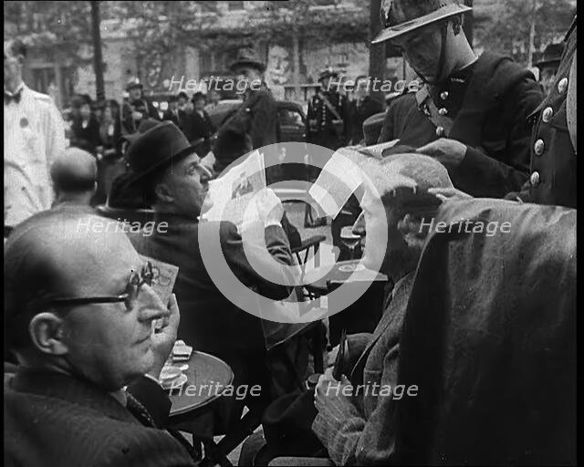 French Police Checking People's Papers Outside a Cafe in Paris, 1940. Creator: British Pathe Ltd.