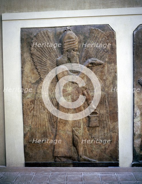 Assyrian relief of a winged genie with a bucket & a cedar cone, Khorsabad, 8th century BC. Artist: Unknown