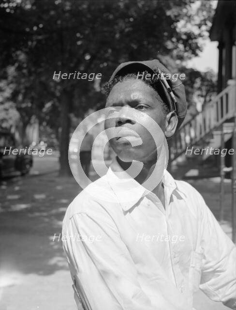 A machine shop worker who lives in the Southwest section, Washington, D.C, 1942. Creator: Gordon Parks.