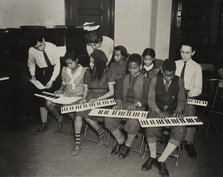 Music classes, keyboards, 1938. Creator: Aubrey Pollard.