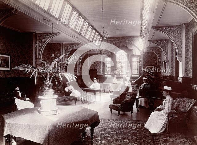 Claybury Asylum, Woodford, Essex: a nurses' day-room (?), (1893?). Creator: London & County Photographic Co.