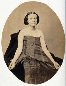 A woman seated; she is partially clothed with her arms extended and the left side of her..., c1865. Creator: L. Haase & Company.