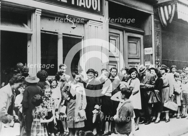 People queuing outside a dairy shop, German-occupied Paris, 26 July 1940. Artist: Unknown