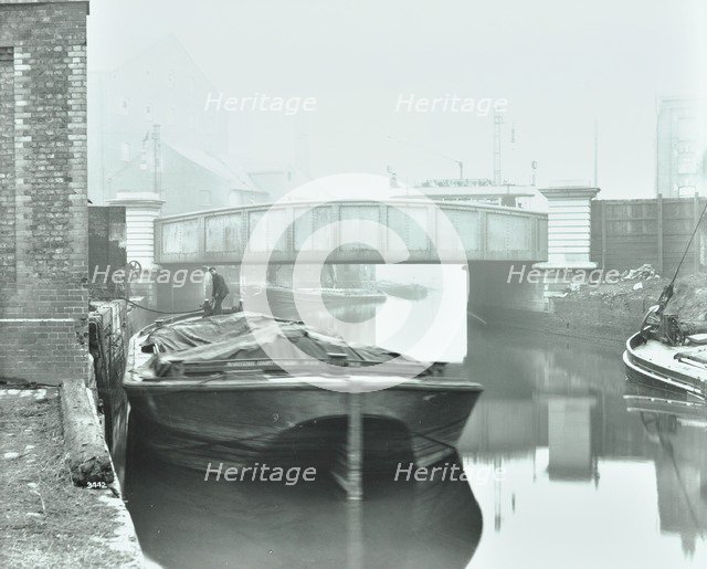 Man mooring a barge by a river bank, Poplar, London, 1905.  Artist: Unknown.
