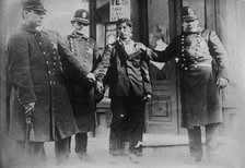 Battered striker with policemen, Philadelphia, 1910. Creator: Bain News Service.