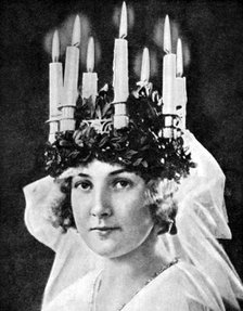 Scandinavian girl wearing candle headdress on St Lucy's Day, 1936.Artist: Fox