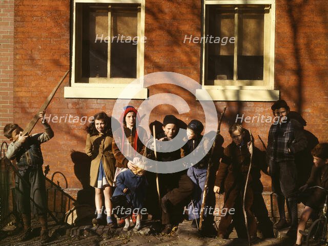 Children aiming sticks as guns, lined up against a brick building, Washington, D.C.?, 1941-1942. Creator: Unknown.