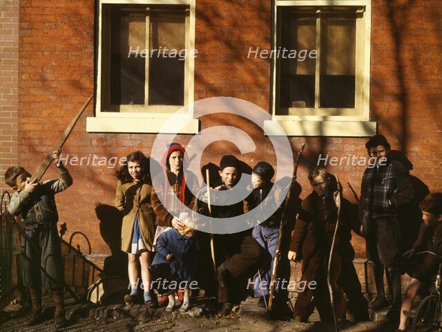 Children aiming sticks as guns, lined up against a brick building, Washington, D.C.?, 1941-1942. Creator: Unknown.