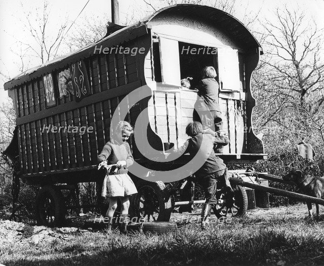 Gypsy children playing outside their caravan, 1960s.
