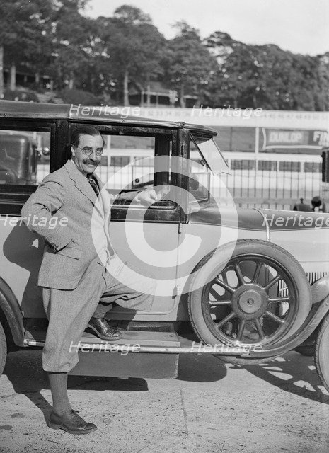 Hugh McConell beside a car, Brooklands, 3 August 1931. Artist: Bill Brunell.