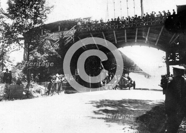 FIAT of Luigi Storero going under a bridge during the 1904 Gordon Bennett Cup, Homburg, Germany. Creator: Unknown.