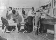 Eskimos doing carpenter work, between c1900 and c1930. Creator: Unknown.