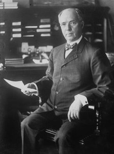 J.D. Archbold, seated holding paper, 1911. Creator: Bain News Service.