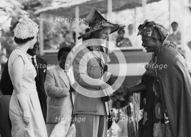 Prince Philip receives a sunhat from Chief Good Gerie, Ghana, 1961. Artist: Unknown