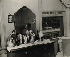 Dresser in the bedroom of Mrs. Ella Watson, a government charwoman, Washington, D.C., 1942. Creator: Gordon Parks.