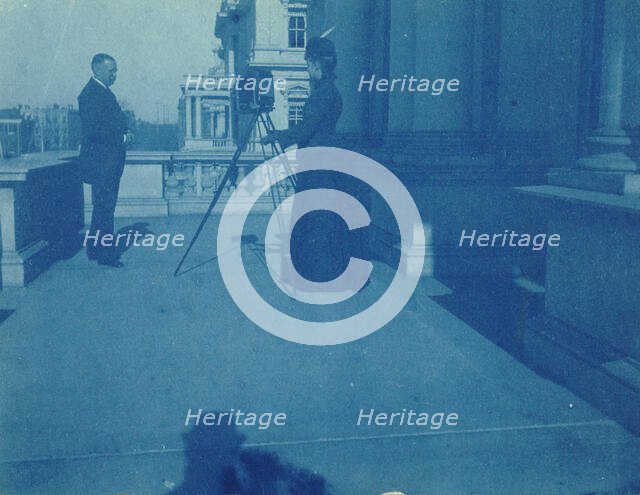 Frances Benjamin Johnston on a balcony of the State, War and Navy Building with a tripod..., 1888. Creator: Frances Benjamin Johnston.