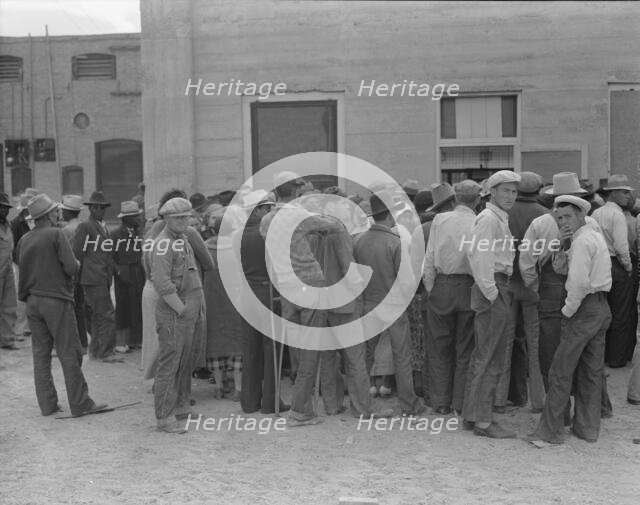 Waiting for the semi-monthly relief checks at Calipatria, California, 1937. Creator: Dorothea Lange.
