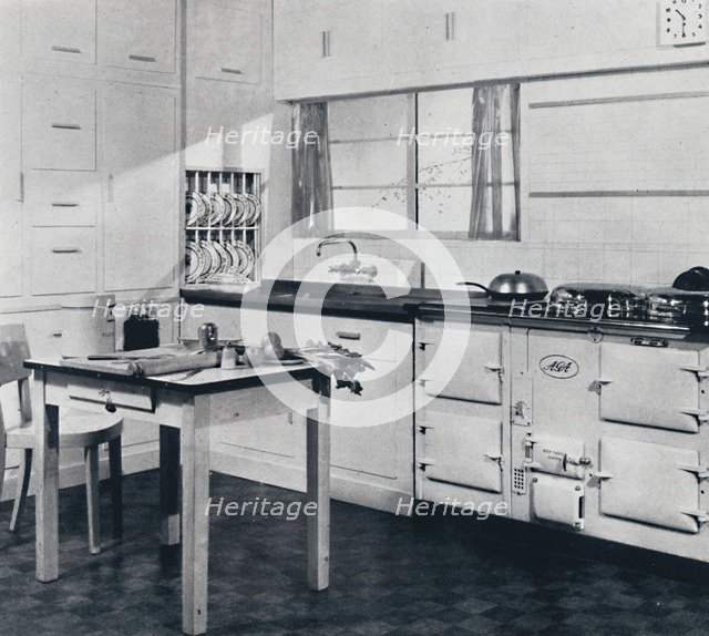 'Aga Heat Ltd. The Model F Aga Cooker (for a large house) finished in black and cream vitreous ename Artist: Unknown.