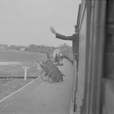 Trainman signalling from a "Jim Crow" coach, Saint Augustine, Florida, 1943. Creator: Gordon Parks.