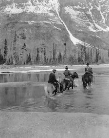 Three campers on horseback cross the Columbia River in Washington, 1903. Creator: Frances Benjamin Johnston.