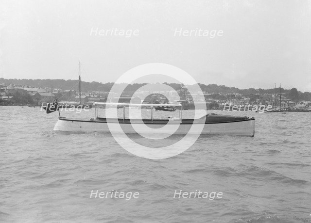 Saunders' motor launch at anchor, 1914. Creator: Kirk & Sons of Cowes.