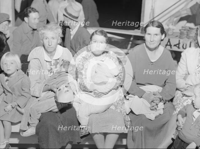 Mothers on the sidelines watch the Halloween party at Shafter migrant camp, California, 1938. Creator: Dorothea Lange.