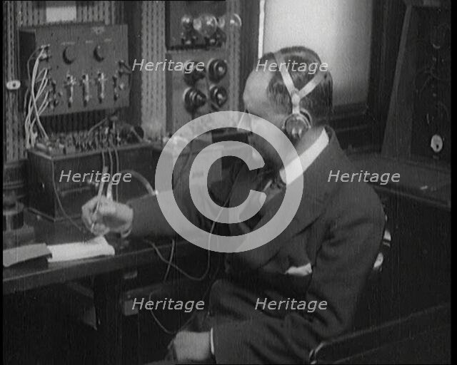 Italian Senator Guglielmo Marconi Using Radio Apparatus While Taking Notes, 1920. Creator: British Pathe Ltd.