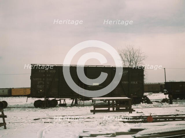 Car jacked up for repairs on the repair tracks, North Proviso, C & NW RR, Chicago, Ill., 1942. Creator: Jack Delano.