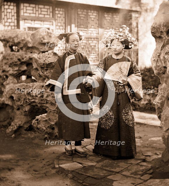 China: a Manchu bride in her wedding clothes with her maid, Beijing, 1869. Creator: John Thomson.