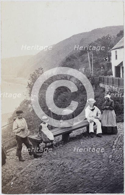 People gathered by the bench at the Lookout in Clovelly, 1860s. Creator: Unknown.