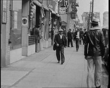 Crowds Walking Down a Pavement, 1930s. Creator: British Pathe Ltd.