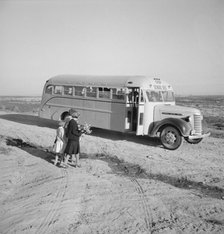Children get into school bus on a fall morning, Dead Ox Flat, Malheur County, Oregon, 1939 Creator: Dorothea Lange.