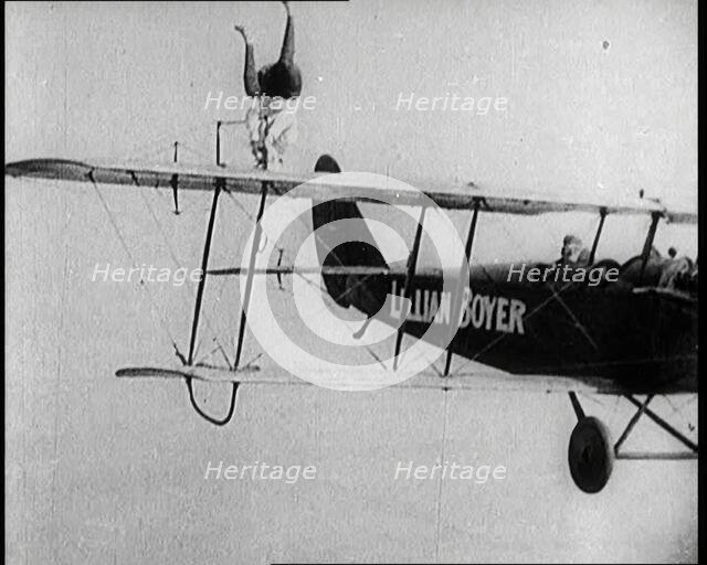 Lilian Boyer Performing Acrobatic Feats from a Flying Biplane, 1922. Creator: British Pathe Ltd.