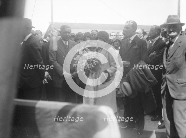 Woman with bouquet, c1935. Creator: Kirk & Sons of Cowes.