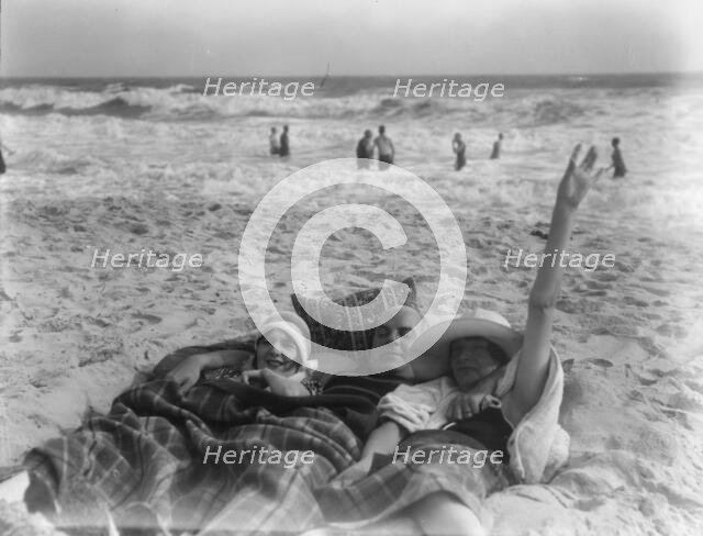Unidentified man and two women at Long Beach, New York, between 1911 and 1942. Creator: Arnold Genthe.