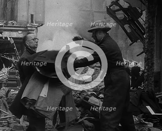 Men Clearing Out Possessions from a Bombed Out Building, 1940. Creator: British Pathe Ltd.
