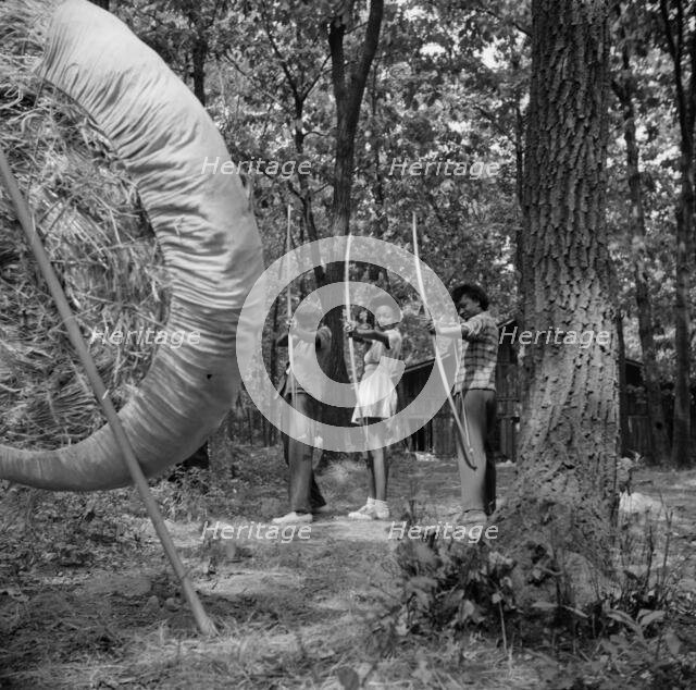 Practicing on the archery range at Camp Fern Rock, Bear Mountain, New York, 1943 Creator: Gordon Parks.